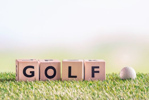 Golf sign with a golf ball on green astro turf