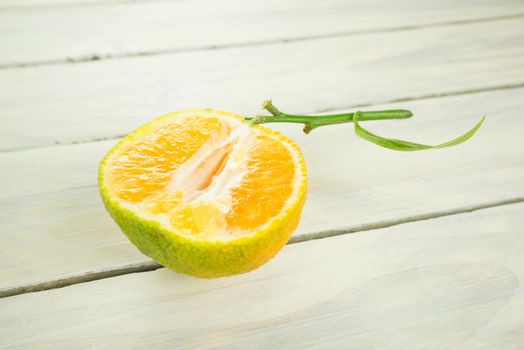 Clementine cutted in half on a wooden table