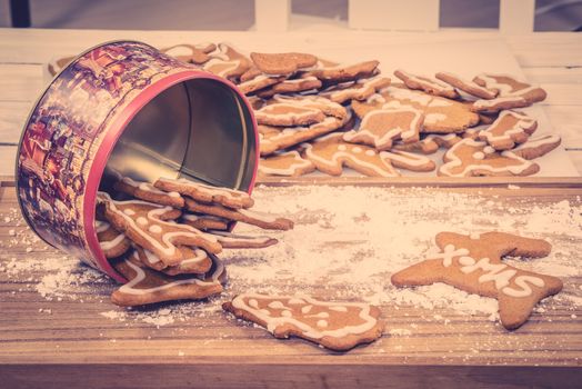Xmas cookies in a cake tin on a kitchen table