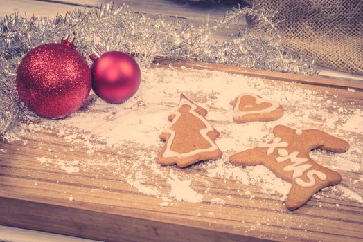 Xmas ornament with homemade cookies on a wooden table