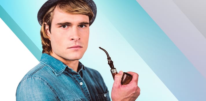 Serious hipster holding pipe against blue vignette background