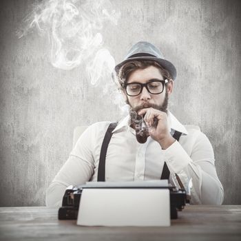 Hipster smoking pipe while sitting looking at typewriter against white and grey background