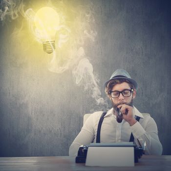 Hipster smoking pipe while sitting looking at typewriter against white and grey background