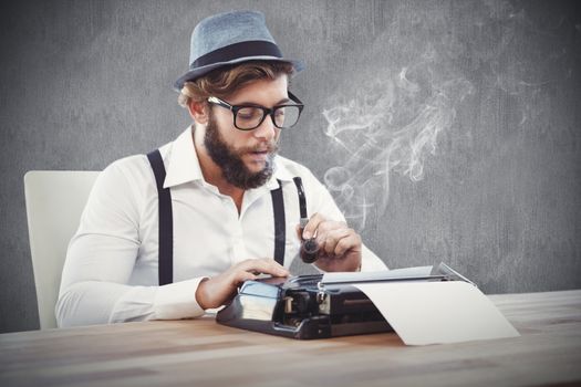 Hipster holding smoking pipe while working on typewriter against white and grey background