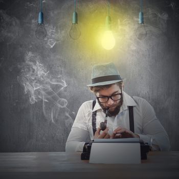 Hipster smoking pipe while working at desk against white and grey background