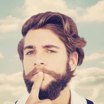 Portrait of hipster with finger on chin against beautiful blue cloudy sky