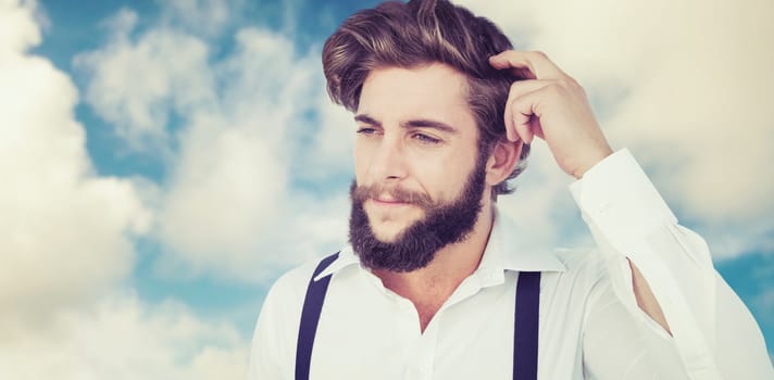 Hipster scratching head while thinking against road leading out to the horizon