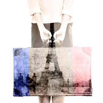 Rear view of hipster woman holding suitcase against eiffel tower