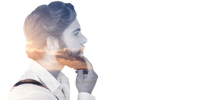 Profile view of hipster touching beard against scenic view of sea against sky