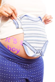 Pregnant woman holding blue pyjamas over her belly