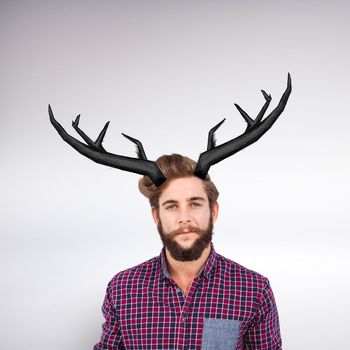 Portrait of confident hipster with clenched fist against grey background