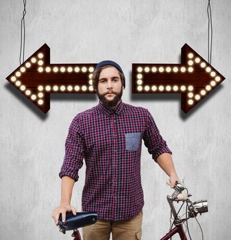 Hipster with bicycle against fence against white and grey background