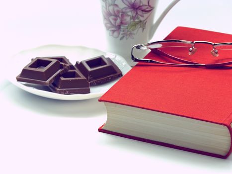 Time to relax - cup of coffee,chocolate,book and glasses , vintage look