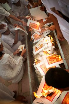 view of people burning papers during vegetarian festival in Thailand