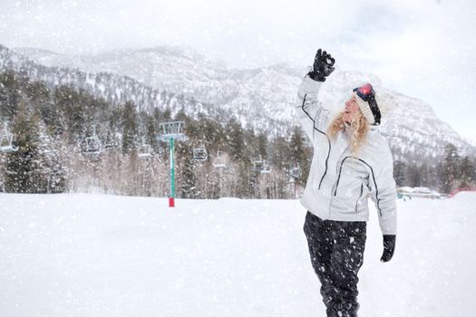 Portrait of young beautiful woman on winter outdoor background