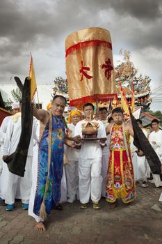 view of people being through the street processing during vegetarian festival in Thailand