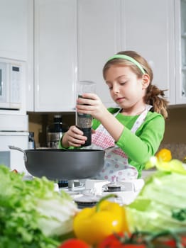 view of young beautiful girl cooking at the kitchen