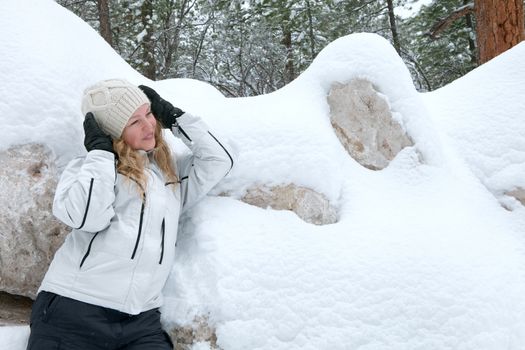 Portrait of young beautiful woman on winter outdoor background