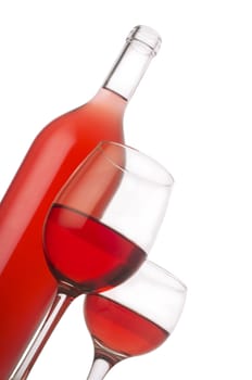 Open rose wine bottle next to a pair of filled up wine glasses. Isolated on white background.