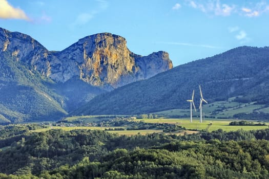 Landscape of mountain with wind turbines the slept of the sun