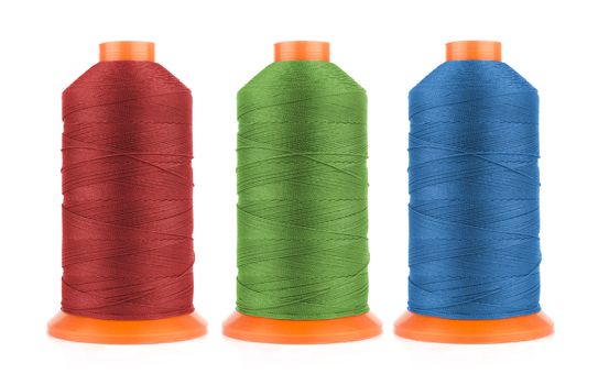 Set of sewing threads in red, blue and green colors isolated on white background