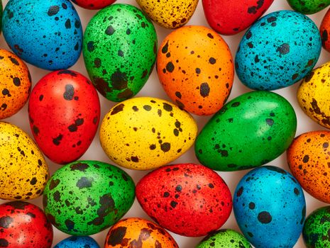 Easter eggs background. Quail eggs hand painted multicolored. Close up. Unusual creative holiday greeting card