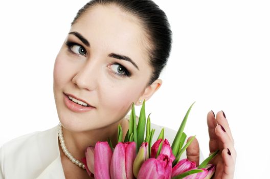 Happy bride with white veil and tulips bouquet in her hand. Young, happy female model.