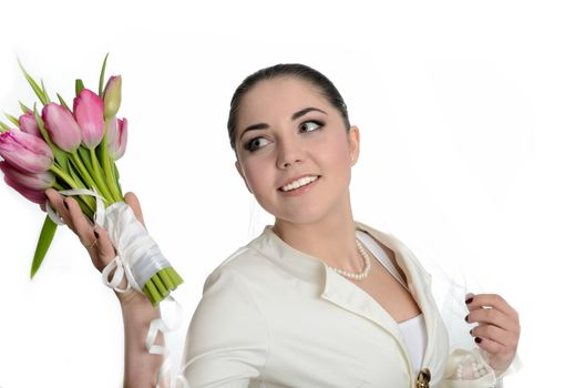 Bride with white veil and white dress throwing tulips bouquet. Female model in studio with white background.