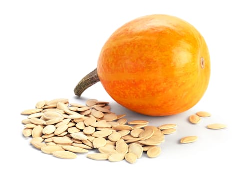 Whole pumpkin and a bunch of seeds isolater on white background.