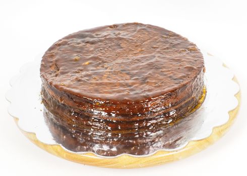 Half stage on sacher torte chocolate cake on silver mirror plate towards white