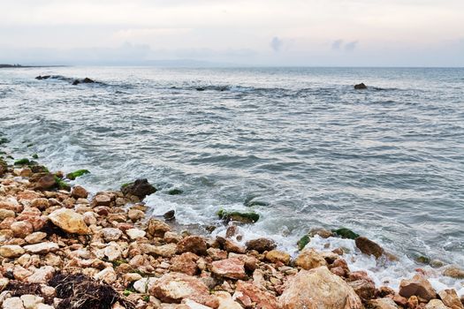 Rocky coast and stormy sea in Tarragona. Catalonia, Spain.