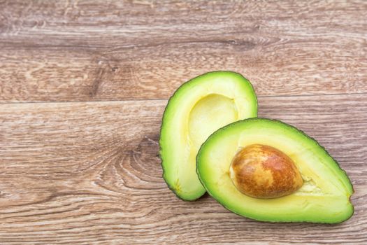 Cut avocado on a wooden background