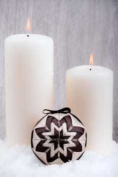 Two candles and christmas decoration on wooden background