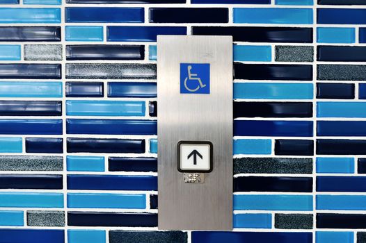 An wheelchair lift symbol in soft light .