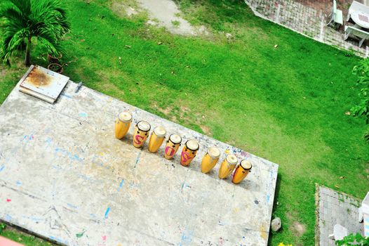 Drum thai on concrete floor and grass .