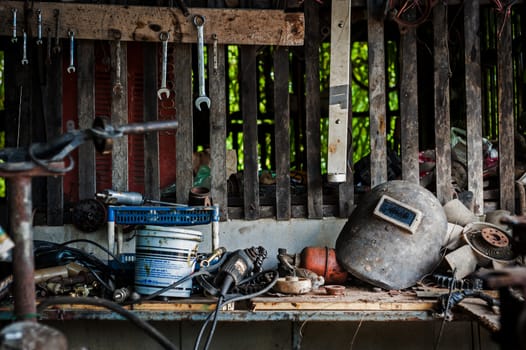 Welding helmet still life in equipment room .