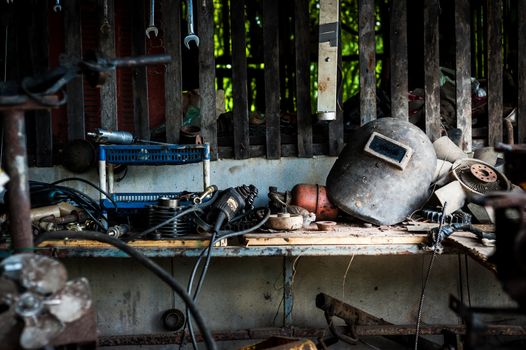 Welding helmet still life in equipment room .