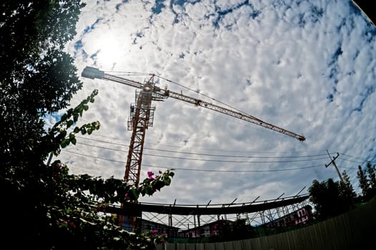 An Crane in construction with blue sky .