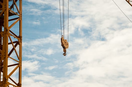 An Crane in construction with blue sky .