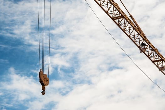 An Crane in construction with blue sky .