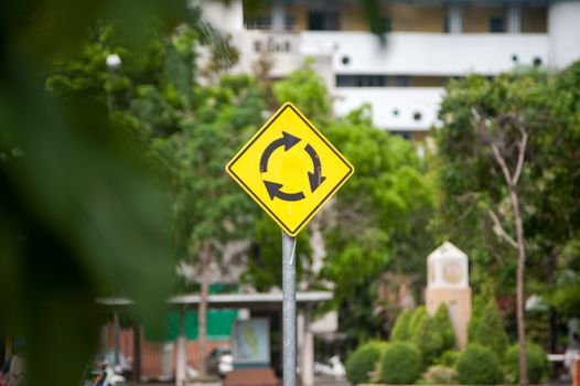 An roundabout  sign in soft light .