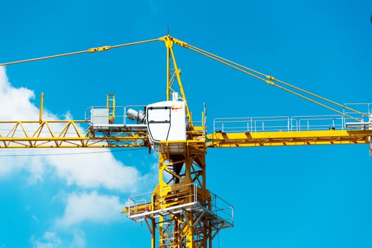 An Crane in construction with blue sky .