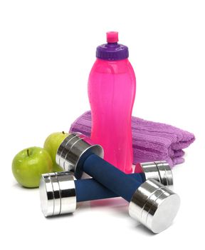 Fitness concept with a bottle of water, a towel, dumbbells and apples isolated