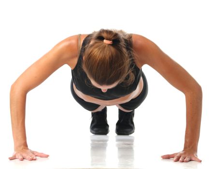 Happy young woman holding doing exercise and stretching over white