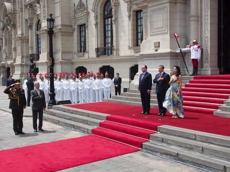 PERU, Lima: Peruvian President Ollanta Humala (c) and his wife Nadine Heredia (R) welcomes French President Francois Hollande (L) in front of the Government Palace, in Lima, on February 23, 2016. Francois Hollande is in Peru for a two-day official visit.
