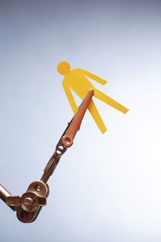 Human rights concept. Yellow paper man in metal clamping device