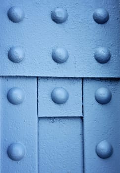 background or texture blue Round iron rivets on the beam