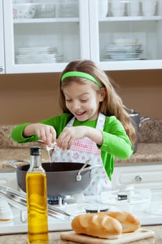 view of young beautiful girl cooking at the kitchen