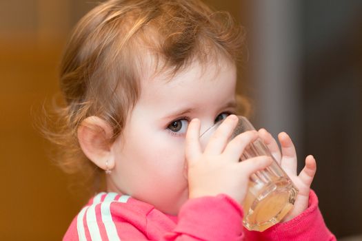 Happy cute little one year old girl indoor in white pink dress