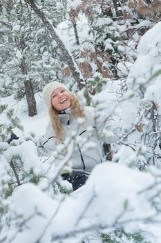 Portrait of young beautiful woman on winter outdoor background